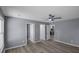 Living room with light wood flooring, neutral paint, and views into the kitchen and other rooms at 2401 Phillips Rd, Lithonia, GA 30058