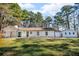 Backyard view of a single-story home with a covered patio and detached garage at 2401 Phillips Rd, Lithonia, GA 30058