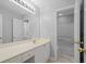 Bathroom with white vanity, a large mirror, and a doorway to a separate toilet and shower area at 2455 Ivey Oaks Rd, Cumming, GA 30041