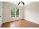 A cozy bedroom offers natural light with hardwood floors and a ceiling fan at 2455 Ivey Oaks Rd, Cumming, GA 30041