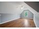 Attic bonus room with wood floors, a ceiling fan, neutral walls, and natural light at 2455 Ivey Oaks Rd, Cumming, GA 30041