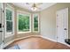 Bright breakfast nook with hardwood floors, ceiling fan, and large windows overlooking a peaceful backyard at 2455 Ivey Oaks Rd, Cumming, GA 30041