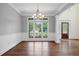 Bright dining room features beautiful hardwood floors, large windows with backyard views, and classic chandelier at 2455 Ivey Oaks Rd, Cumming, GA 30041