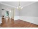 Open concept dining room featuring hardwood floors and easy access to the living room with a fireplace at 2455 Ivey Oaks Rd, Cumming, GA 30041