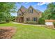 Inviting two-story home with a well-maintained lawn, mature landscaping, and a welcoming facade at 2455 Ivey Oaks Rd, Cumming, GA 30041