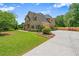 Lovely two-story home with lush greenery, manicured lawn, and a spacious driveway at 2455 Ivey Oaks Rd, Cumming, GA 30041