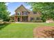 Attractive two-story home with a well-kept lawn, mature trees, and a welcoming front entrance at 2455 Ivey Oaks Rd, Cumming, GA 30041