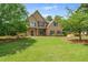 Charming two-story home with manicured lawn and mature trees in a desirable neighborhood at 2455 Ivey Oaks Rd, Cumming, GA 30041