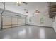 Spacious three-car garage with epoxy floor, windows, and ceiling fans at 2455 Ivey Oaks Rd, Cumming, GA 30041