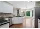 An eat-in kitchen features stainless steel appliances, granite countertops, and large windows at 2455 Ivey Oaks Rd, Cumming, GA 30041