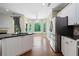 A spacious kitchen features stainless steel appliances, granite countertops, and backyard views at 2455 Ivey Oaks Rd, Cumming, GA 30041