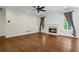 Inviting living room with hardwood floors, cozy fireplace, ceiling fan, and windows with natural light at 2455 Ivey Oaks Rd, Cumming, GA 30041