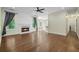 Open-concept living room with fireplace, hardwood flooring, ceiling fan, and natural light from the backyard at 2455 Ivey Oaks Rd, Cumming, GA 30041