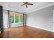 This bedroom features hardwood floors, a ceiling fan, and neutral colors at 2455 Ivey Oaks Rd, Cumming, GA 30041