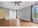 A spacious main bedroom includes hardwood floors, a ceiling fan, and an en suite bathroom at 2455 Ivey Oaks Rd, Cumming, GA 30041