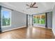 The main bedroom features hardwood floors, a ceiling fan, and natural light at 2455 Ivey Oaks Rd, Cumming, GA 30041