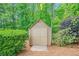 Outdoor shed surrounded by trees and shrubs and a mulch base at 2455 Ivey Oaks Rd, Cumming, GA 30041