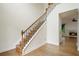 Elegant staircase features hardwood steps, wrought iron spindles, and leads to an open landing with views of the living room at 2455 Ivey Oaks Rd, Cumming, GA 30041