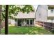 View of the backyard with covered patio and fenced perimeter at 556 Poplar Bnd, Canton, GA 30114