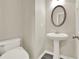 Elegant bathroom with a pedestal sink and oval mirror at 556 Poplar Bnd, Canton, GA 30114