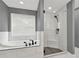 Bathroom with a soaking tub and a glass-enclosed shower at 556 Poplar Bnd, Canton, GA 30114