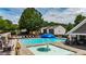 Community Pool with a splash pad in a zero entry wading pool, lounge chairs, tables, umbrellas, and landscaping at 556 Poplar Bnd, Canton, GA 30114