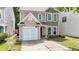 Charming two-story home featuring a one-car garage and well-maintained front yard at 556 Poplar Bnd, Canton, GA 30114
