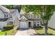 Charming two-story home with a well-manicured lawn and attached single car garage at 556 Poplar Bnd, Canton, GA 30114