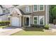 Charming two-story home with a one-car garage and inviting front entrance at 556 Poplar Bnd, Canton, GA 30114