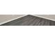 Close-up of gray wood-look flooring with white baseboards at 556 Poplar Bnd, Canton, GA 30114