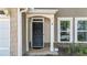 Inviting front door with decorative columns and stone accents, enhancing curb appeal at 556 Poplar Bnd, Canton, GA 30114