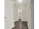 Hallway leads to a powder room with hardwood floors at 556 Poplar Bnd, Canton, GA 30114