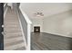 Open living area with staircase, fireplace, ceiling fan, and stylish gray-toned flooring at 556 Poplar Bnd, Canton, GA 30114