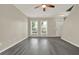 Bright living room with wood floors, ceiling fan, and large windows at 556 Poplar Bnd, Canton, GA 30114