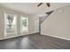 Bright living area with modern flooring, natural light, and staircase at 556 Poplar Bnd, Canton, GA 30114
