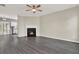 Bright living area with fireplace, modern flooring, ceiling fan, and open layout to kitchen at 556 Poplar Bnd, Canton, GA 30114
