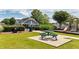 A picnic table, grill, and trash can are located next to the playground in the community at 556 Poplar Bnd, Canton, GA 30114