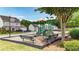 Community playground with climbing structures, benches, and green space surrounded by residential houses at 556 Poplar Bnd, Canton, GA 30114