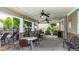 Covered poolside patio with tables, chairs, and fans for a relaxing and enjoyable outdoor experience at 556 Poplar Bnd, Canton, GA 30114