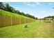 Dog-friendly park with green grass, fencing, and play structures for pets at 1303 Wingate Way, Atlanta, GA 30350