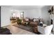 Bright living room with a comfortable couch, area rug, and adjacent dining area at 1303 Wingate Way, Atlanta, GA 30350
