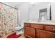 Bathroom with a shower/tub with curtain, toilet, and a vanity with a sink at 1622 Honeysuckle Path, Conyers, GA 30012