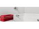 Close up of a white bathtub with chrome faucet fixtures and a red bag sitting on the edge at 1622 Honeysuckle Path, Conyers, GA 30012