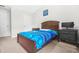 This bedroom features a bed with blue and black covers and matching decor at 1622 Honeysuckle Path, Conyers, GA 30012