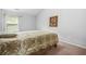 Neutral bedroom featuring a large bed with a patterned brown and green comforter at 1622 Honeysuckle Path, Conyers, GA 30012