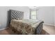 Comfortable bedroom featuring a tufted headboard, soft carpet, and bright natural light at 1622 Honeysuckle Path, Conyers, GA 30012
