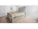 Cozy bedroom featuring a comfortable bed with a tufted headboard and neutral decor at 1622 Honeysuckle Path, Conyers, GA 30012