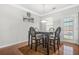 Cozy dining room featuring hardwood floors, a modern light fixture, and neutral paint at 1622 Honeysuckle Path, Conyers, GA 30012