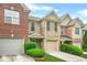 Brick townhouse with attached garage, tidy landscaping, and front entry at 1622 Honeysuckle Path, Conyers, GA 30012