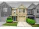 Charming townhome featuring a two-car garage, well-maintained lawn, and inviting entryway at 1622 Honeysuckle Path, Conyers, GA 30012
